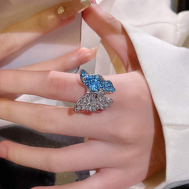 Glamorous ethnic-inspired silver butterfly crystal ring on woman's finger