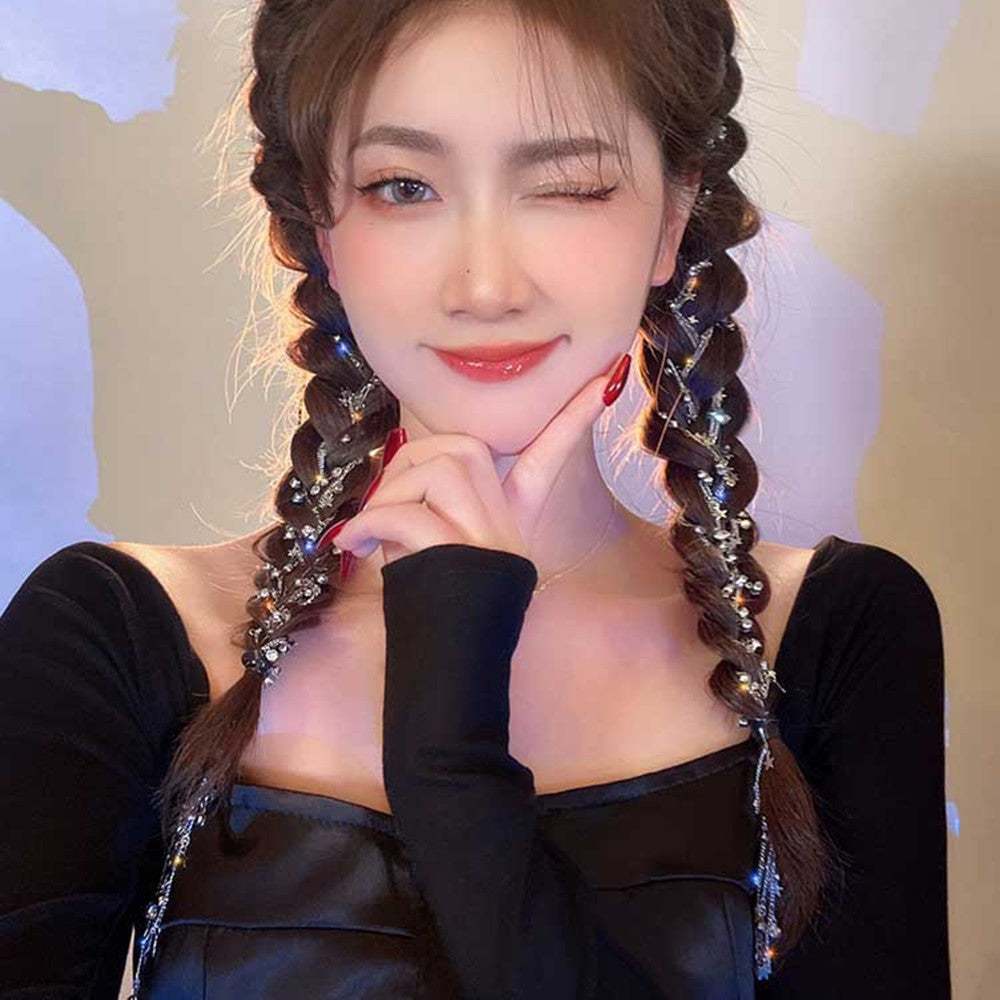 Woman with braided hair wearing rhinestone star-shaped hair braid side chain clip in black outfit