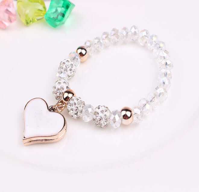 Elegant heart crystal bracelet with clear beads and a gold heart charm, perfect for adding a touch of style.