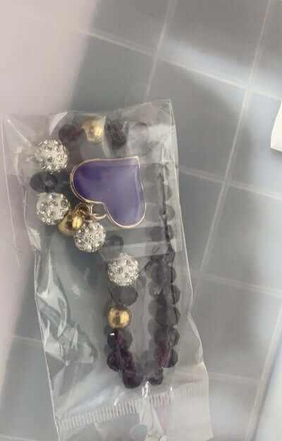 Heart crystal bracelet featuring purple heart charm and shimmering beads in an elegant packaging.