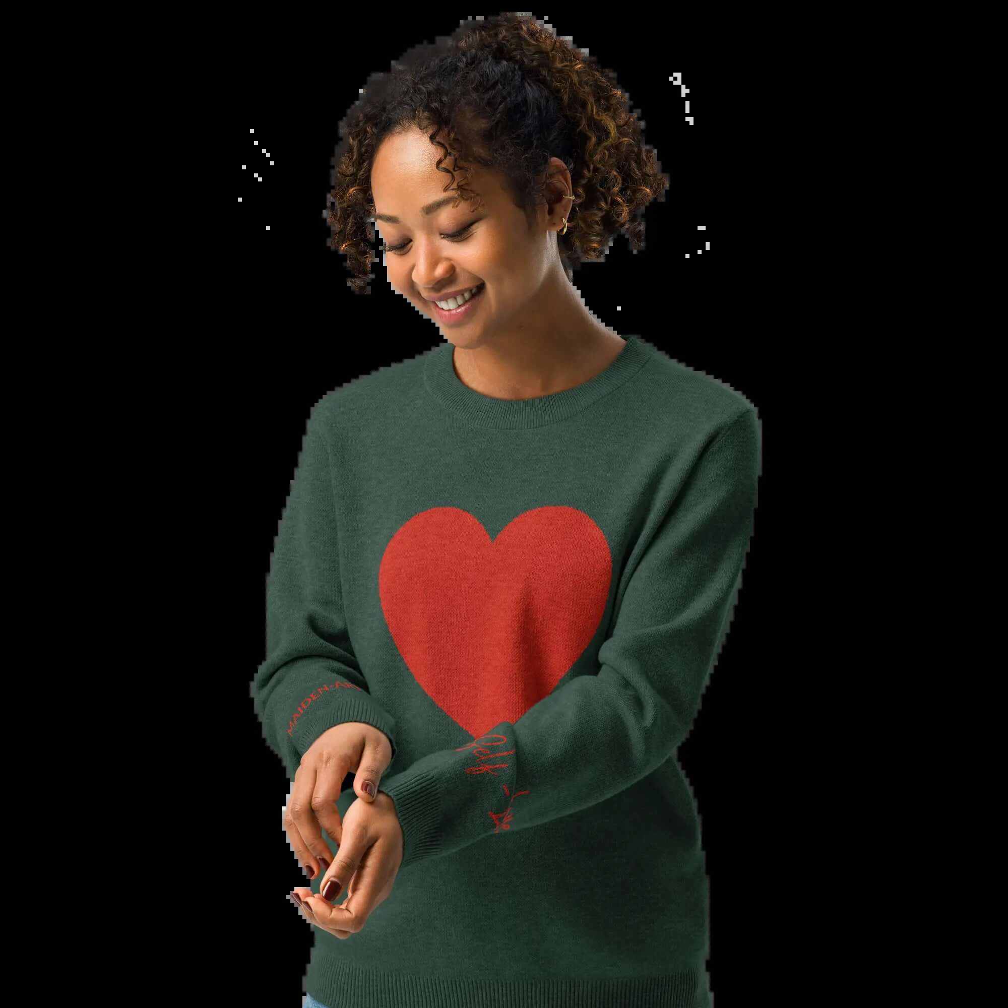Woman smiling in a pine green crew sweater with a large red heart design, perfect for casual or dressy occasions.