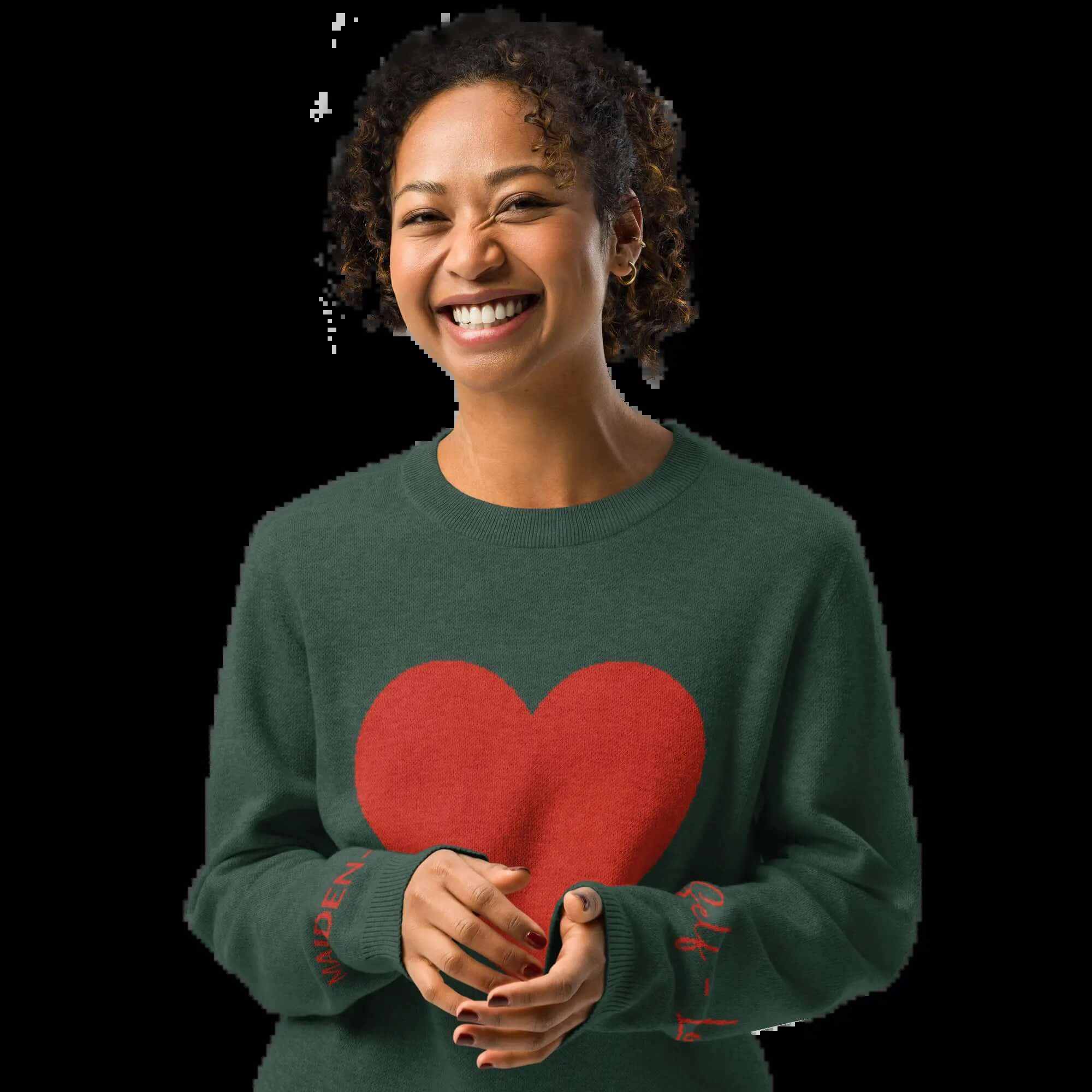 Woman smiling in a heart pattern pine green knit crew sweater with a red heart design.