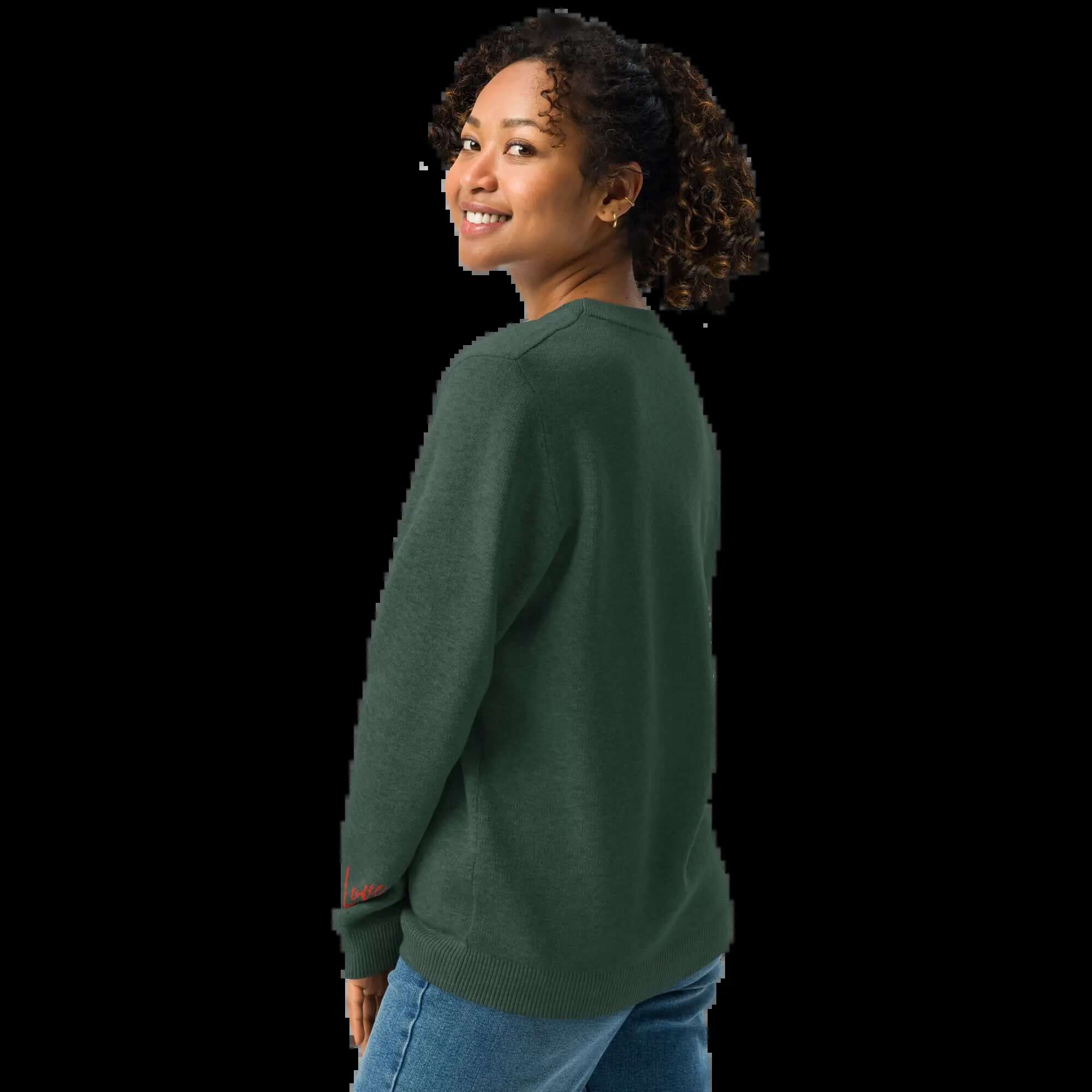 Back view of a woman wearing a pine green knit crew sweater, showcasing its relaxed fit and comfortable style.