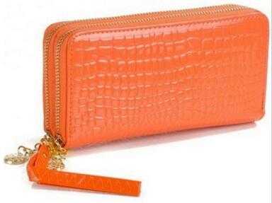 High quality women's leather wallet in orange crocodile texture with double zipper and wrist strap