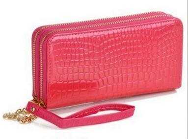 High quality women's leather wallet in pink crocodile texture with gold zipper and wrist strap