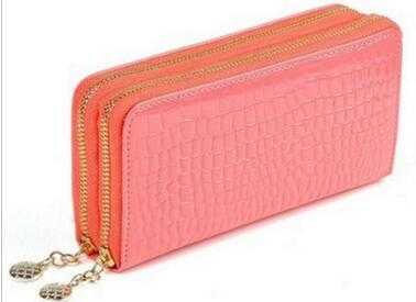 High quality women's leather wallet in pink with gold zippers and crocodile texture