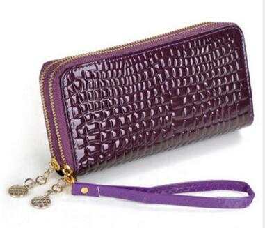 High quality women's leather wallet in glossy purple with zip closure and wrist strap