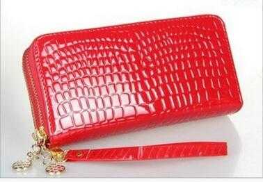 Red women's leather wallet with crocodile texture and gold zipper details