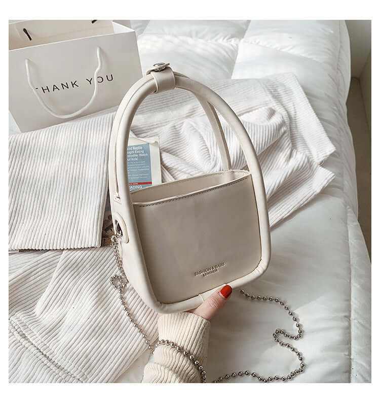 Women’s luxury designer mini chain handbag in beige with soft surface and chain handle