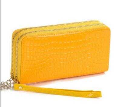 Yellow women's leather wallet with textured finish and wrist strap detail