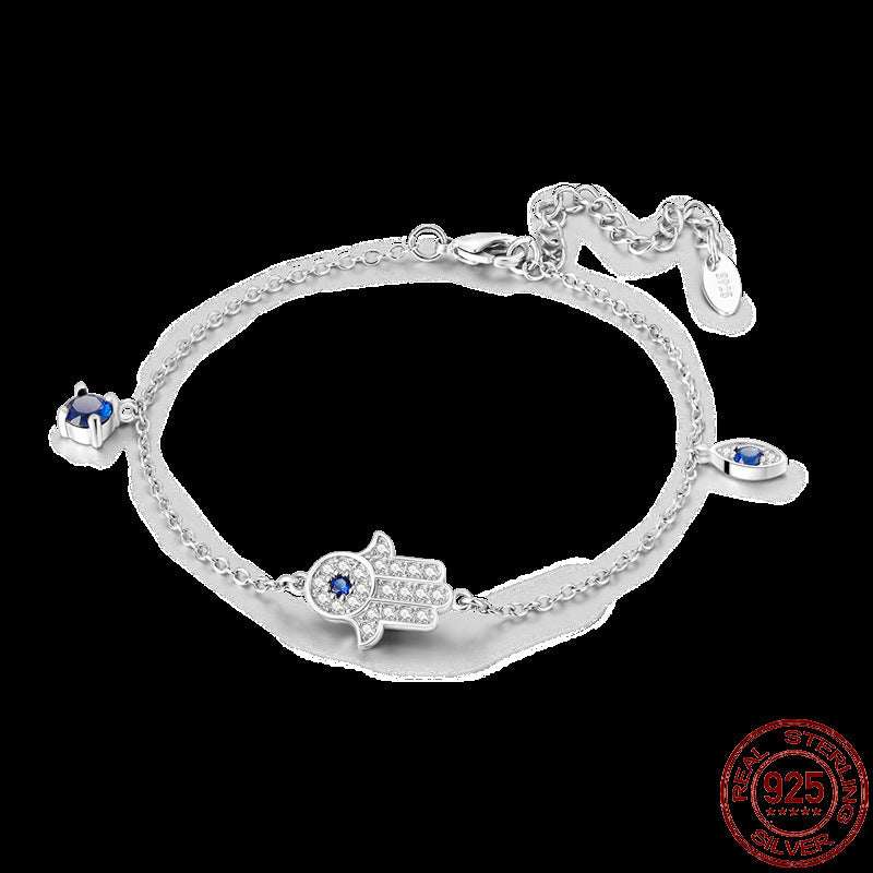 Infinity Hamsa sterling silver bracelet with blue gemstones and adjustable clasp on black background