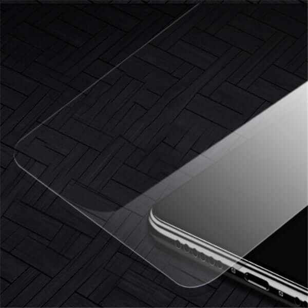 Tempered glass screen protector installed on a smartphone, showcasing its clarity and design on a dark textured background.