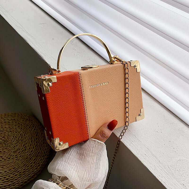Elegant ladies clutch purse box with a stylish handle and gold accents, perfect for parties.