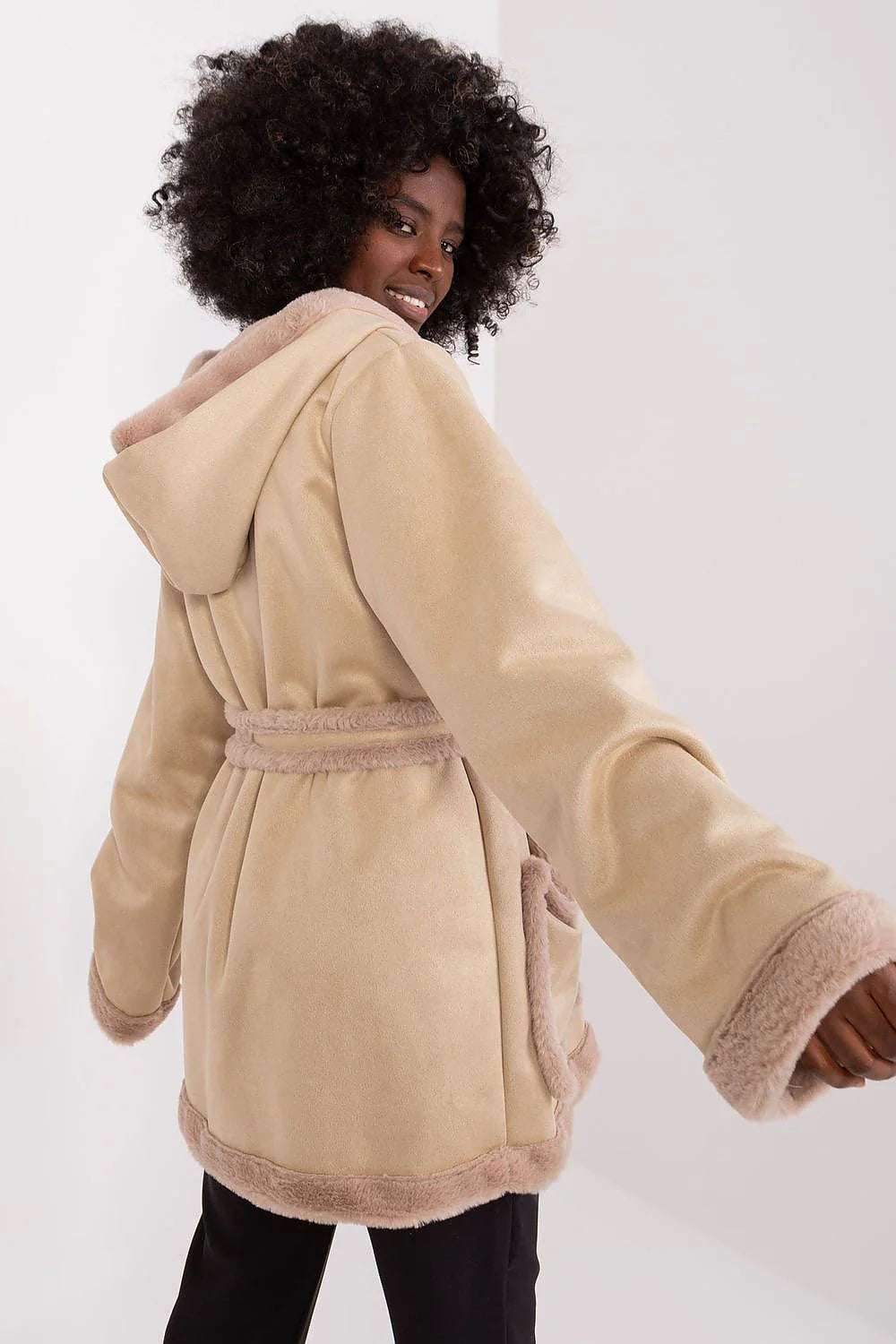Back view of a model wearing the Lakerta Elegant Double Breasted Coat with a spacious hood and soft fur trim.