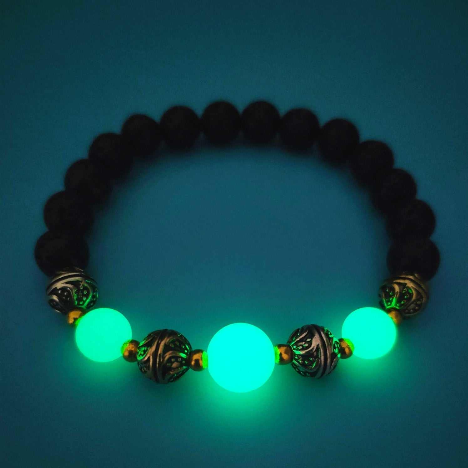 Luminous beaded bracelet for women with glowing green fluorescent stones and antique bronze beads on elastic rope