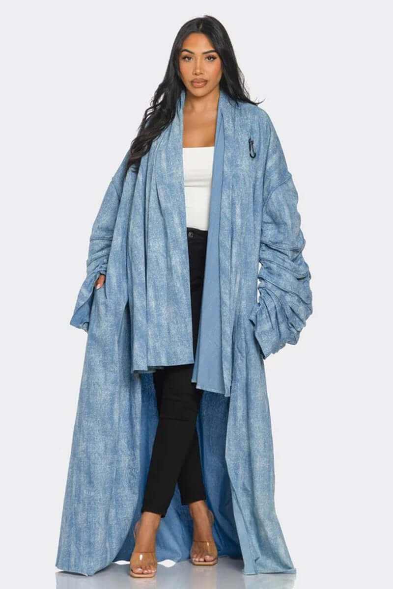 Stylish woman wearing a maxi longline denim duster coat with ruched sleeves and a light wash denim finish.