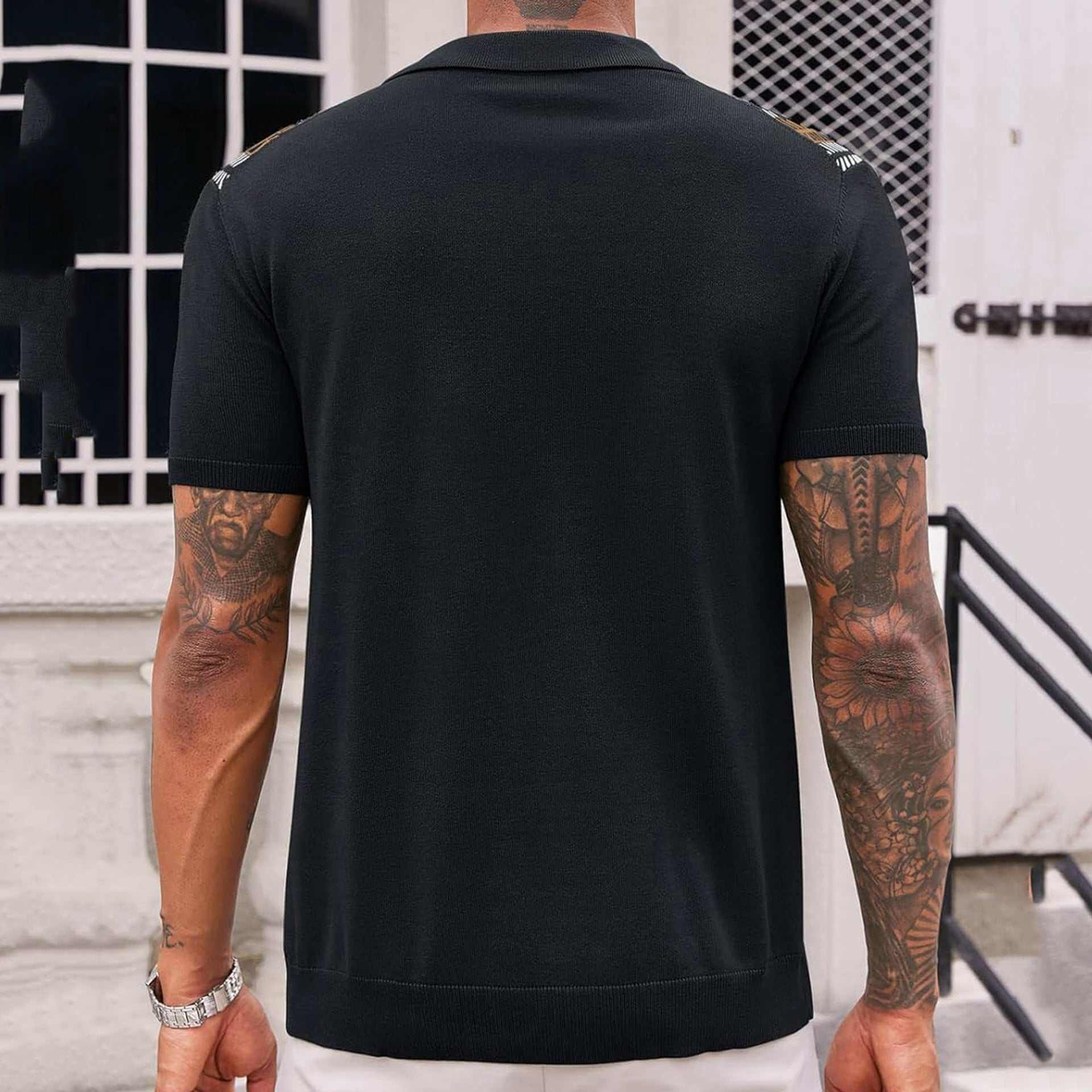 back view of men's short sleeve black striped jacquard sweater with tattoos on arms