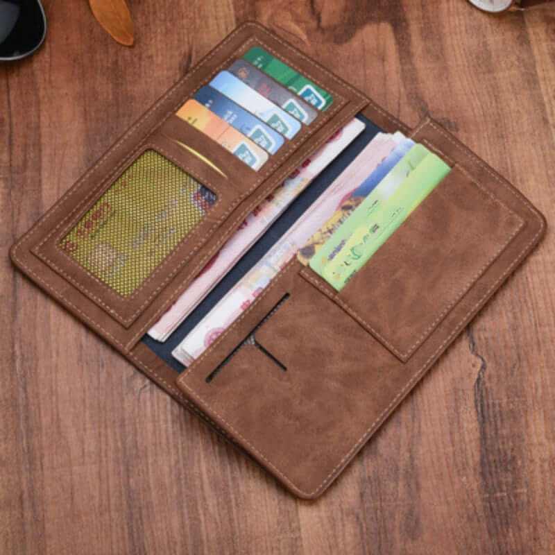 Men's compact genuine leather wallet with card slots and cash compartment on wooden surface.