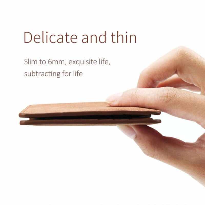 Slim and compact leather wallet held in hand, showcasing its delicate design and 6mm thickness.