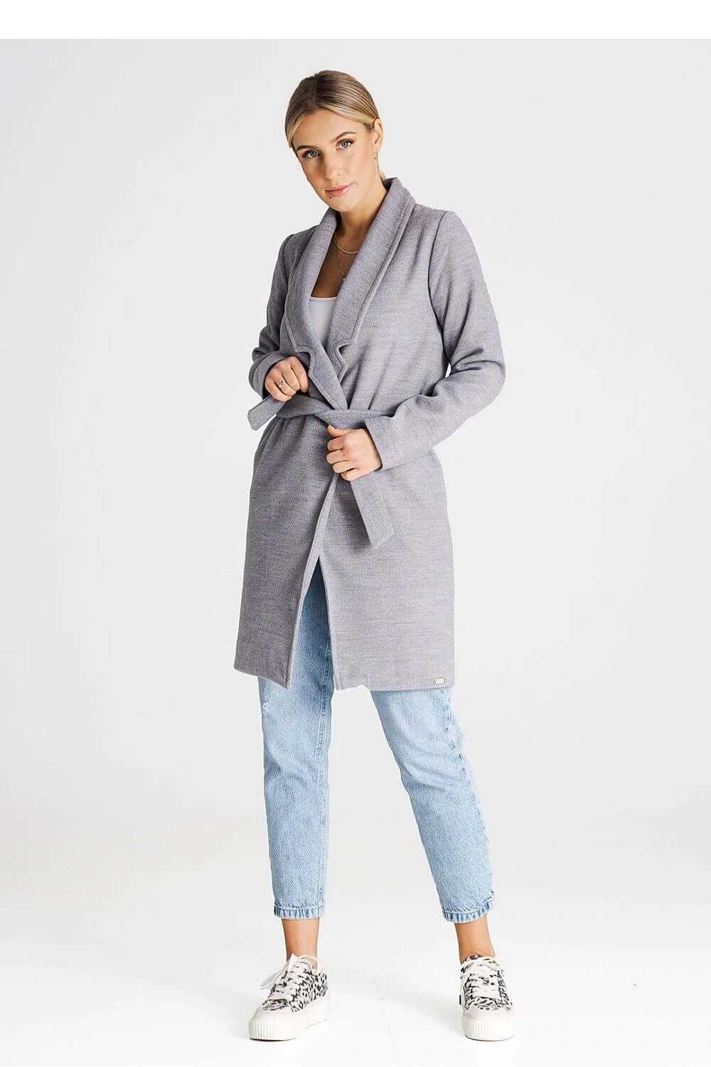Minimalist Figl buttoned midi coat worn with a belt, featuring large collar and side pockets. Elegant gray knit design.