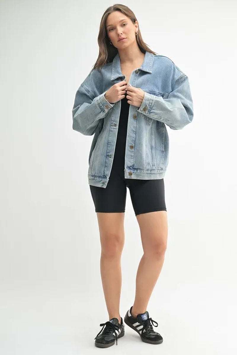 Model wearing a MONO B boxy-cut denim jacket with a relaxed fit, paired with black shorts and sneakers.