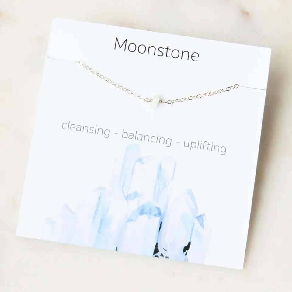 Moonstone necklace with cleansing, balancing, and uplifting properties, displayed on a stylish card.