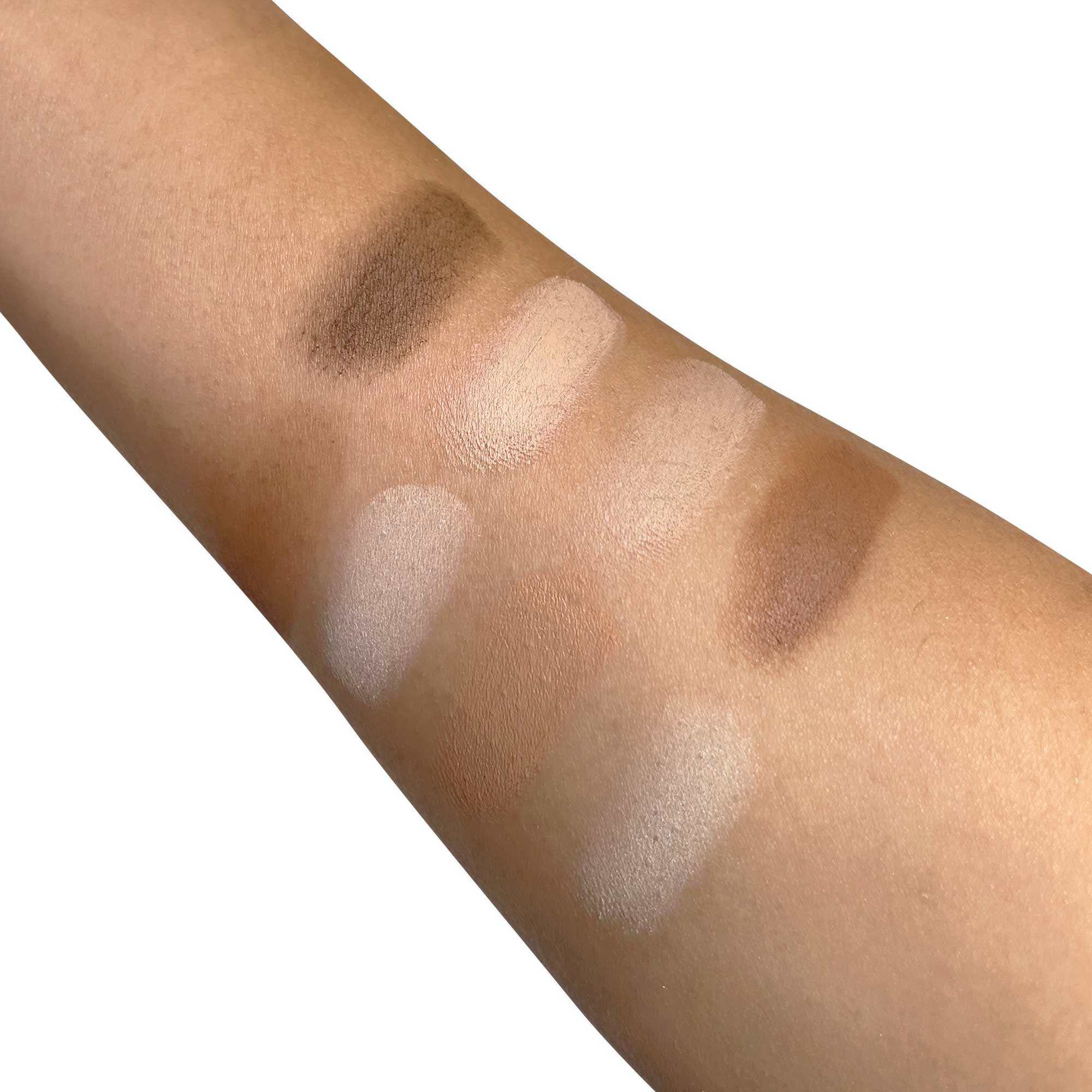 Swatches of the Natural Glow Ultimate Contour Palette's cream and matte shades on an arm.