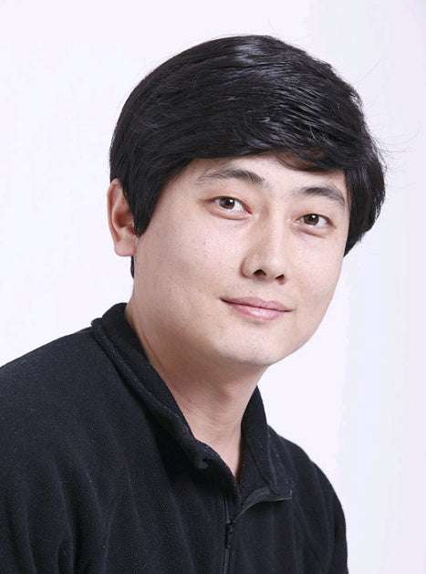 Natural Look Men's short black real hair wig on man with natural skin tone