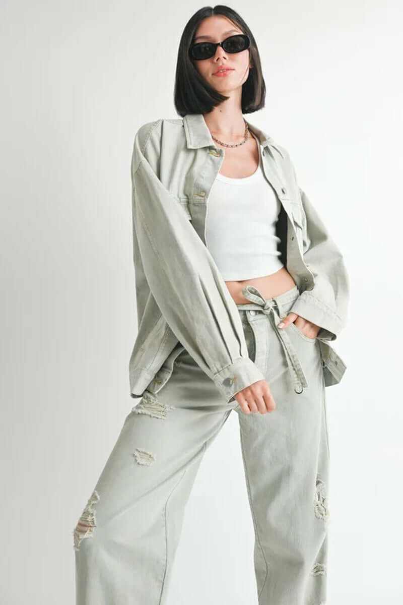 Oversized denim jacket styled with a white top and distressed pants, model height 5'9, made of 100% cotton.