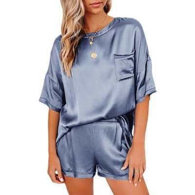 Women wearing blue silk short sleeve pajama set with pocket for home sleepwear and leisure.