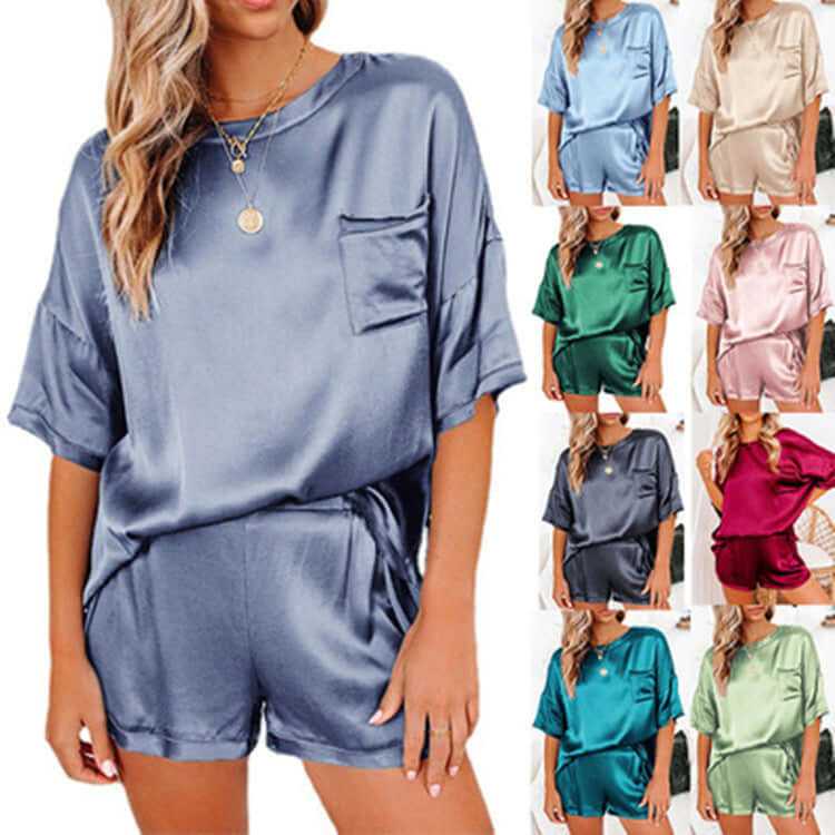 Women's short sleeve silk pajama set in various colors, featuring a relaxed fit top and shorts for comfortable home wear.