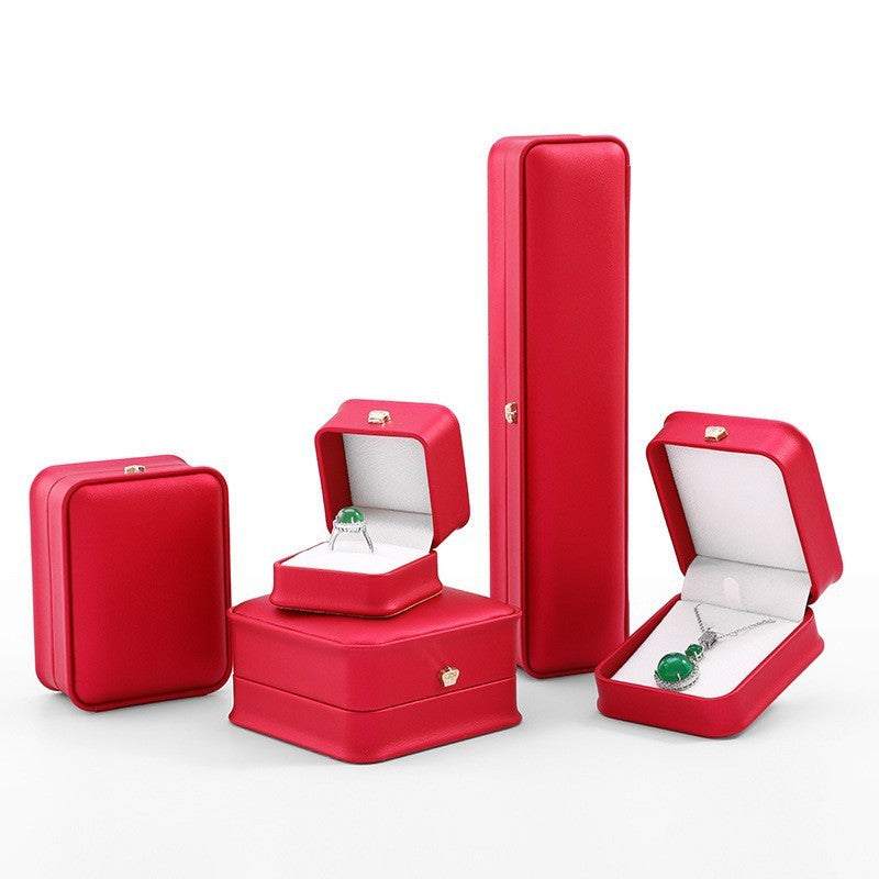 Elegant red jewelry display case set including boxes for rings, necklaces, and bracelets.