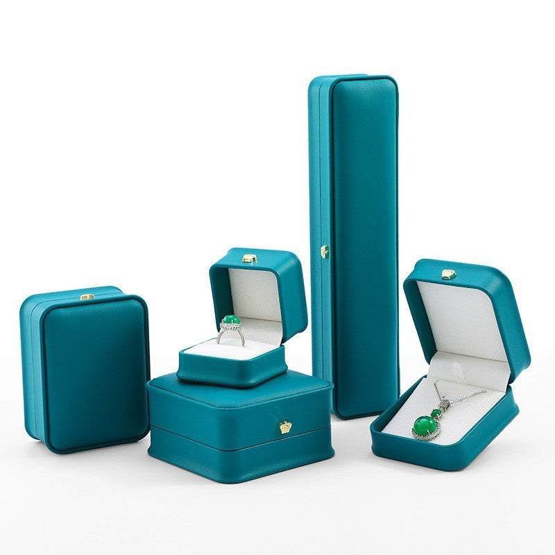 Stylish teal jewelry display case set for rings, necklaces, and bracelets, perfect for gifts and proposals.