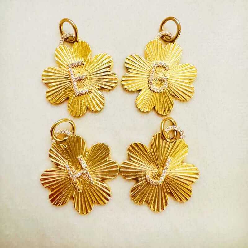 Gold flower charm clips featuring initials E, C, L, and J, perfect for personalized jewelry accessories.