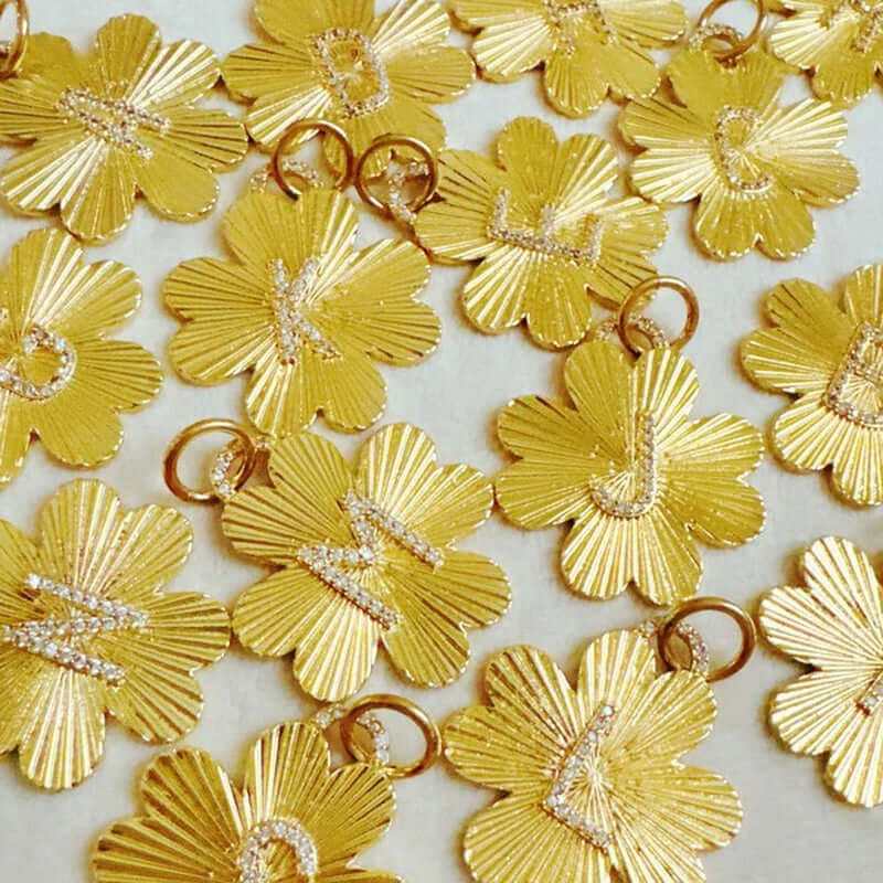 Personalized gold clover charms with initials, perfect for necklaces or bracelets, adding a unique touch to accessories.