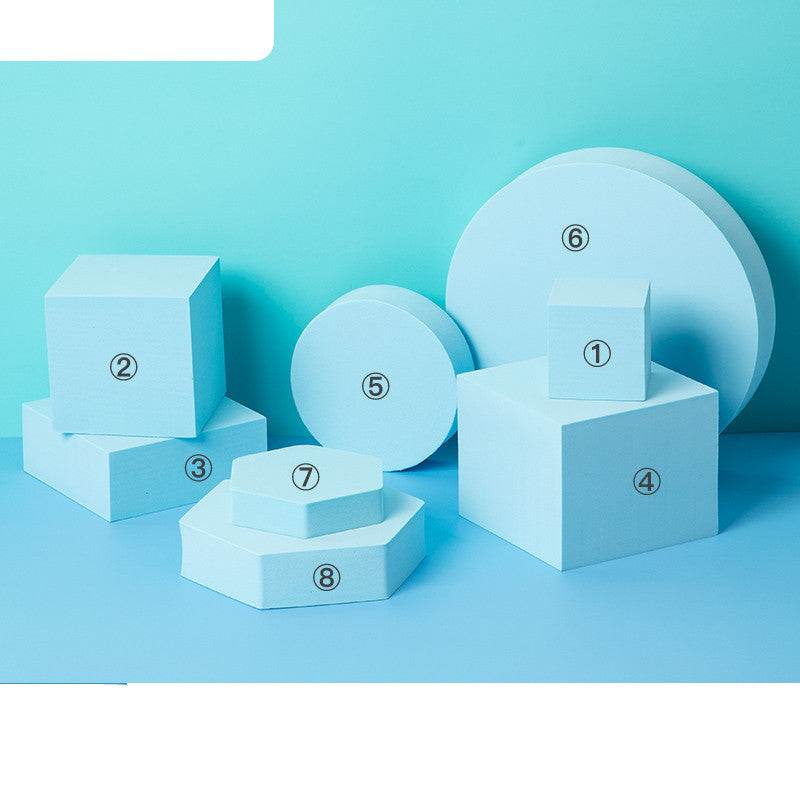 Photo Prop Geometric Cube Decor set with numbered light blue foam shapes including cubes, cylinders, and hexagons on a blue background