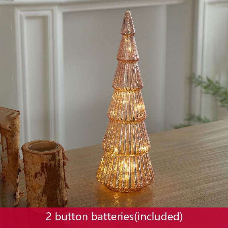 Christmas table decorations featuring a pink glitter Christmas tree with warm lights on a table.