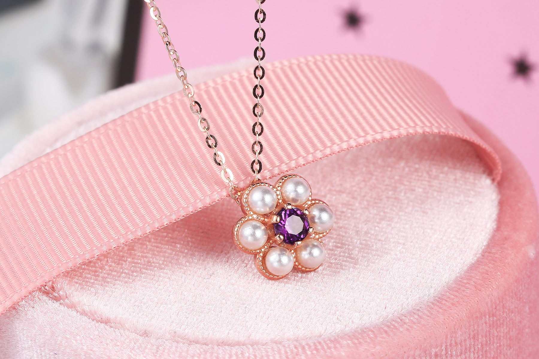 Plum Charm Amethyst Tassel Necklace with silver chain and flower pendant featuring amethyst gem and pearls on pink background