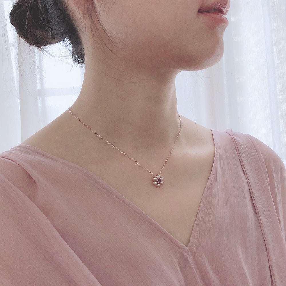 Plum Charm Amethyst Tassel Necklace in silver with floral pendant on woman wearing pink blouse