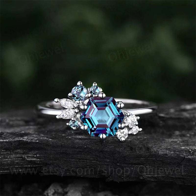 Prismatic Brilliance Six-Claw Zircon Ring with blue geometric centerpiece and clear accents on silver band
