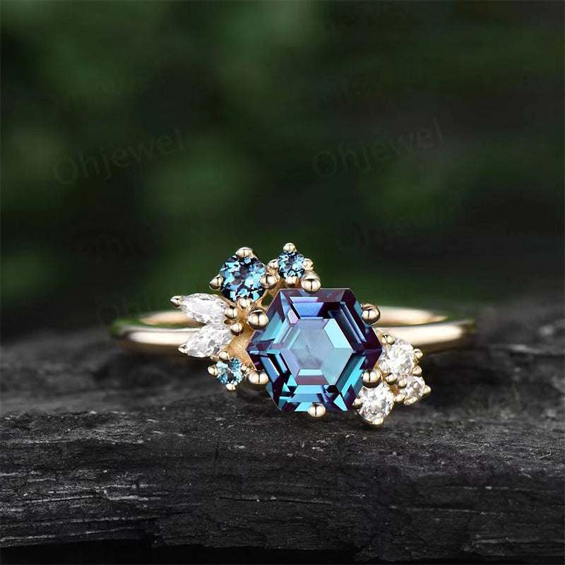 Prismatic Brilliance six-claw zircon ring with blue hexagonal stone and clear accent stones, gold zinc alloy band for women