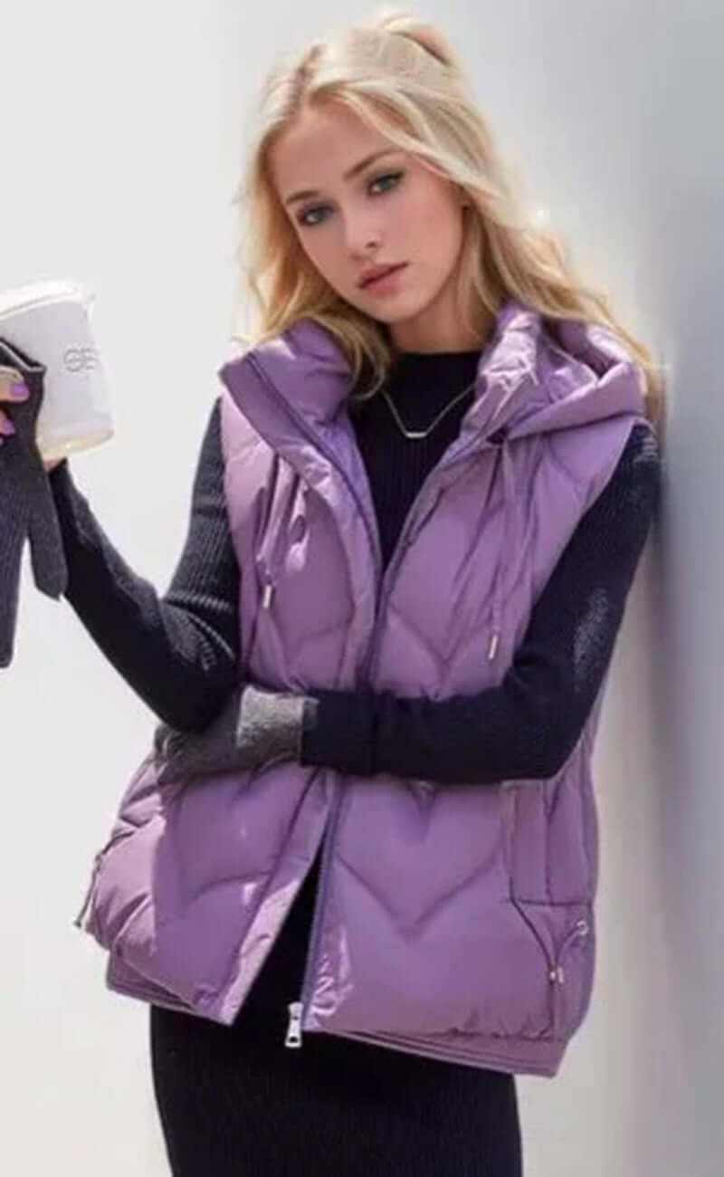 Stylish woman wearing a lavender puffer vest with hoodie, perfect for casual winter outfits.