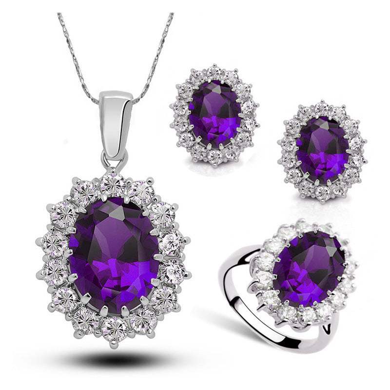 Bridal crystal jewelry set with purple stones and silver metal including necklace, earrings, and ring