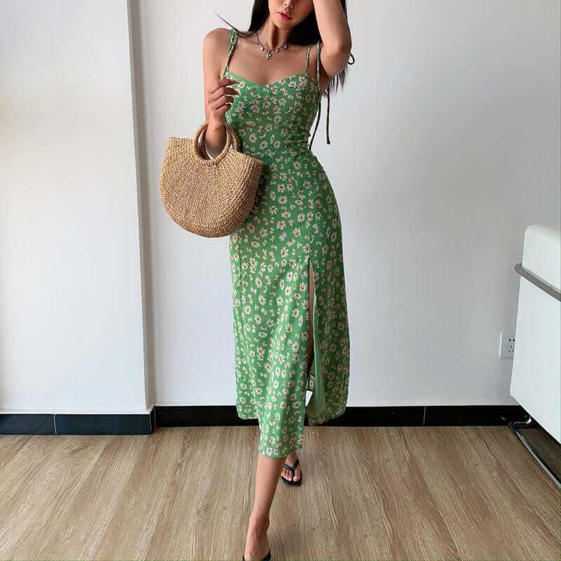 Green floral midi dress with side slit, high waist, and sling straps, perfect for holidays and vintage-inspired looks.