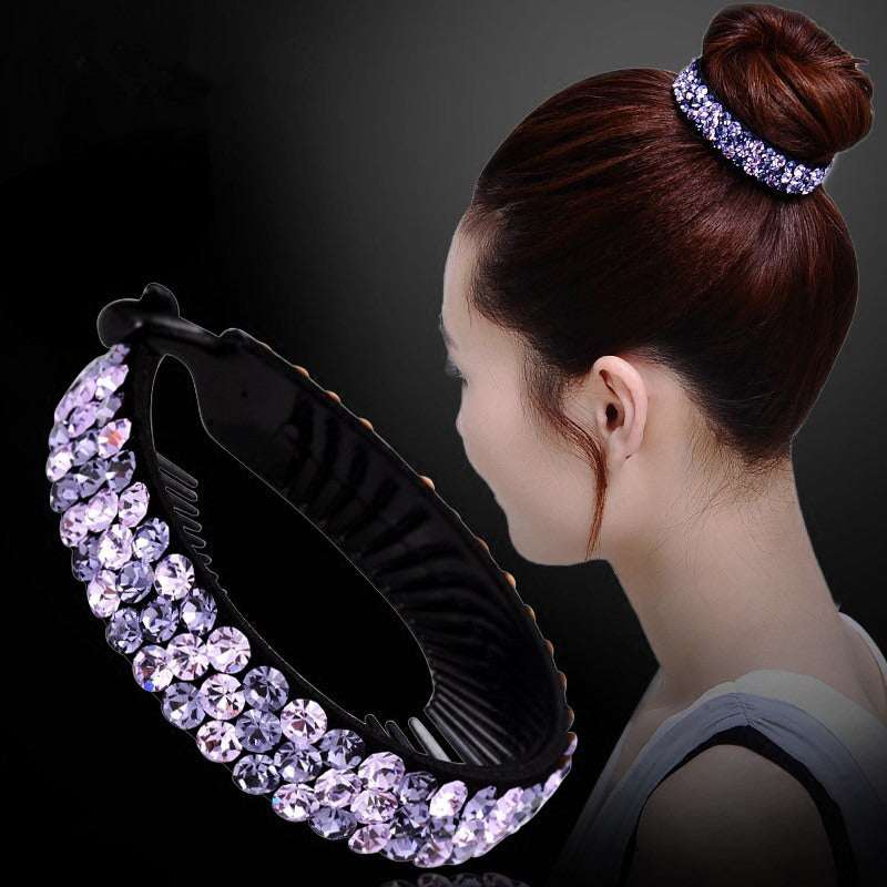 Purple rhinestones hair claw clip holding a woman's bun hairstyle