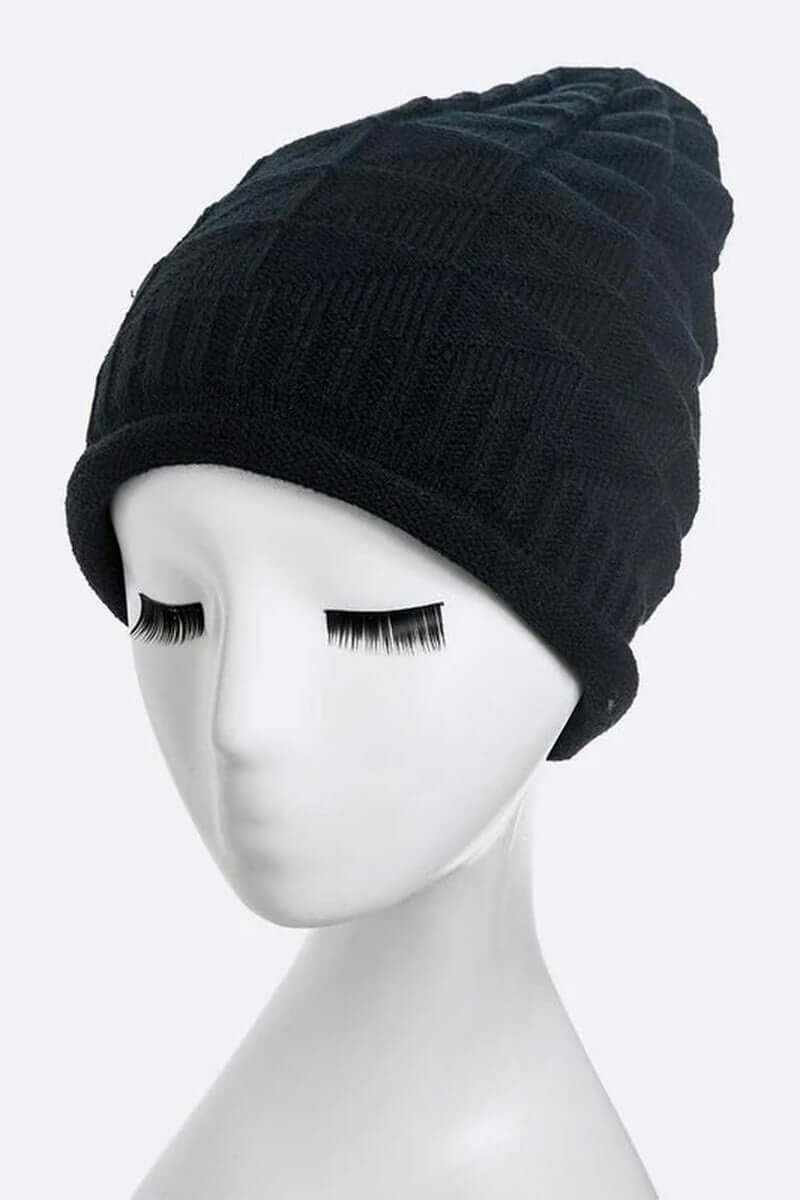 Ribbed slouchy unisex knit beanie displayed on a mannequin head, showcasing its stylish design and texture.