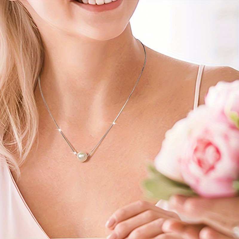 Elegant woman wearing a single pearl necklace with a 14K gold chain, ideal as a romantic Valentine's gift.
