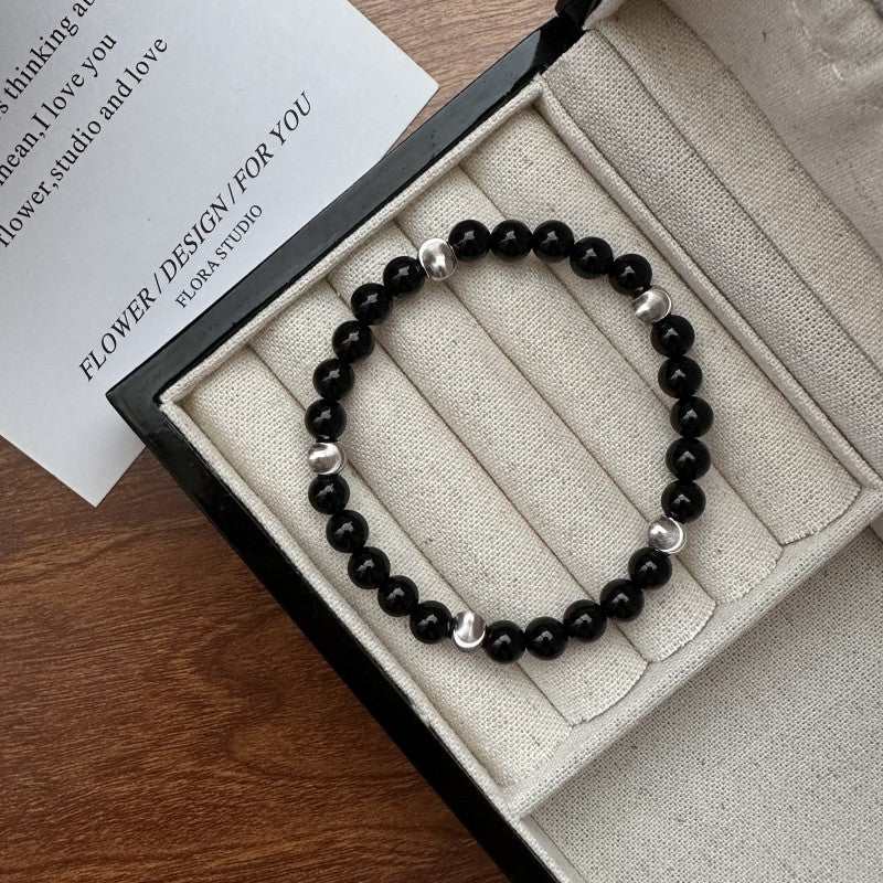 Sterling silver black agate cat's eye bracelet with round beads in a jewelry box