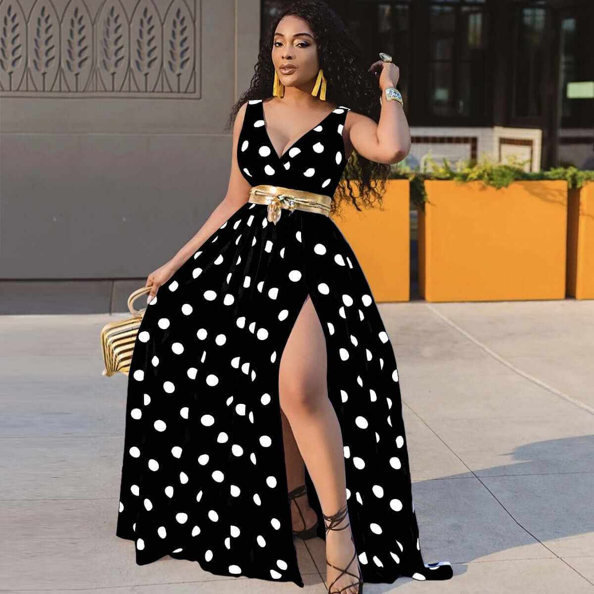 Stylish black and white polka dot plus size dress with a thigh-high slit and golden belt, perfect for parties.