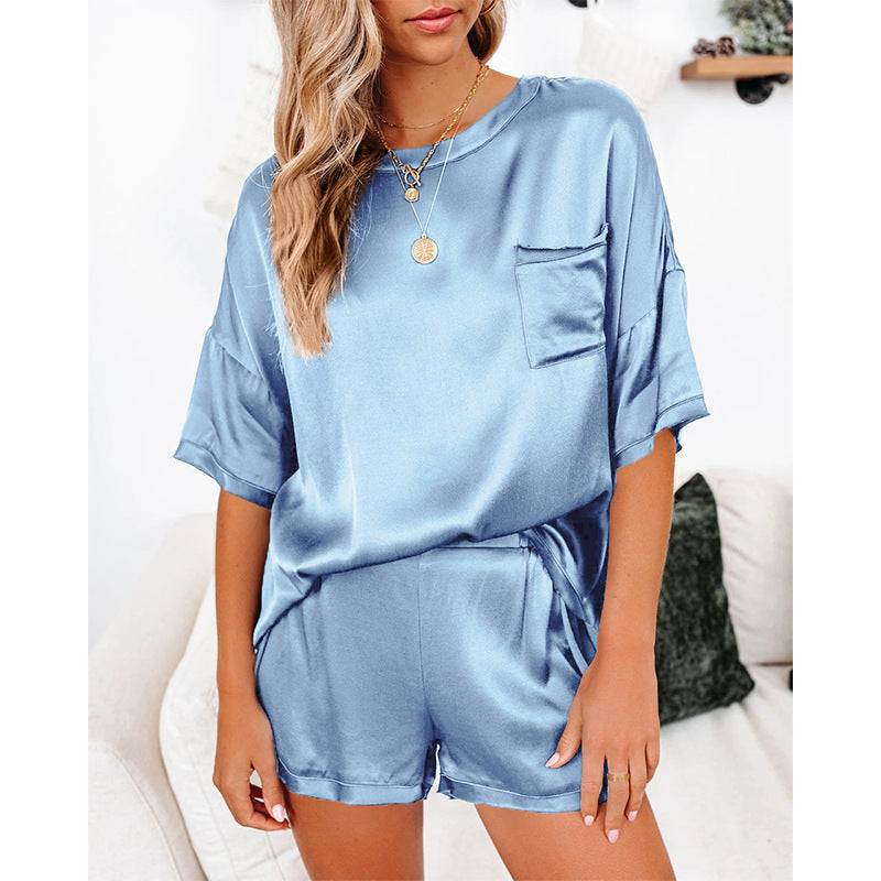 Women’s short sleeve silk pajama set in peacock blue, featuring a relaxed fit and pocket detail for lounging.